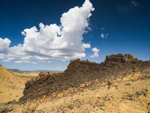 hardened mud wall and clouds near Chaco Ruins, Rio Puerco Valley, New Mexico