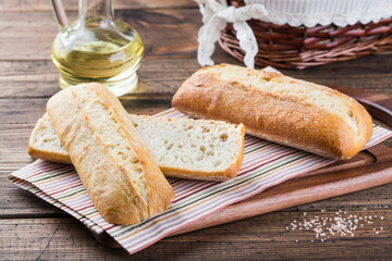 baguettes on a towel, French bread, wooden background