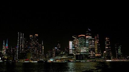 New York skyline in night lights, midtown Manhattan. Breathtaking panoramic view of night city financial district with skyscrapers. Night view of modern urban architecture landscape.