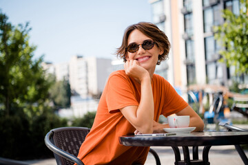 Photo of cute sweet good mood girl drinking tea outdoors enjoying weekend warm weather