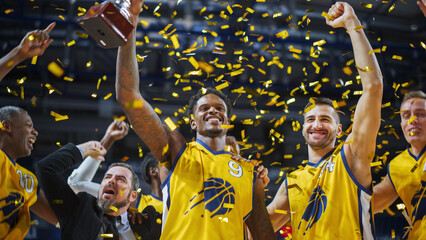 Multiethnic Basketball Players Celebrate Championship Victory with Hugs, Jumping, And Holding the Trophy High. Exclusive Joyful Sports Action on Live TV and Pay Per View Internet Streaming Concept.