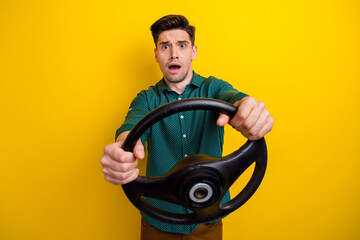 Fototapeta na wymiar Photo of worried nervous guy dressed green stylish clothes riding fast own car vehicle isolated on yellow color background