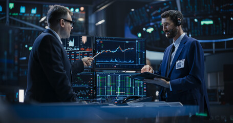 Two Successful Traders Analyzing Real-Time Financial Data and Reports About the State of the Finance Market. Stock Exchange Professionals Discussing Buy and Sell Options For Different Bonds - obrazy, fototapety, plakaty