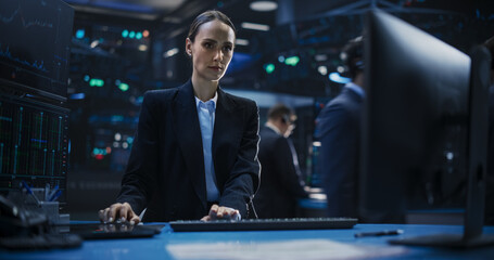 Portrait of a Female Stockbroker Working in an International Stock Exchange Office. Beautiful Trader Using Desktop Computer, Creating Buy and Sell Orders Online with the Help of a Financial Software