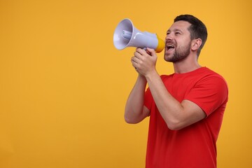 Special promotion. Man shouting in megaphone on orange background. Space for text