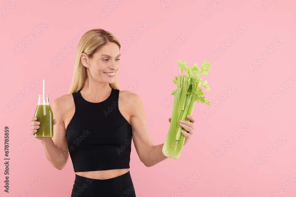 Poster Happy woman holding glass bottle with tasty celery juice and fresh vegetable on pink background. Space for text