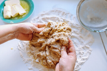 Female hands kneading dough