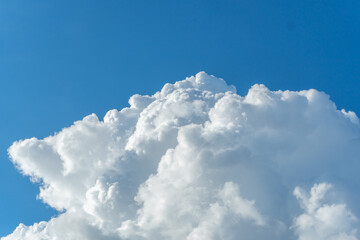 Naklejka na ściany i meble Large cloud on clear blue sky background with copy space for wallpaper.