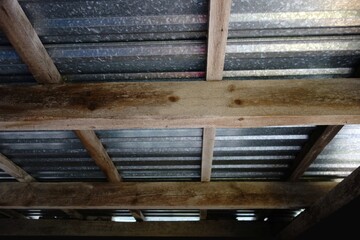 Metal roof with a ceiling made of spruce beams