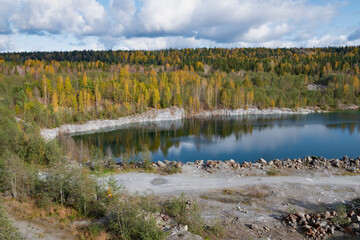 View of the old flooded marble quarry in the vicinity of Ruskeala in golden autumn. Karelia, Russia