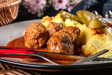 Meatballs pork and mashed potatoes topped with paprika gravy.