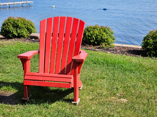 Empty outdoor Adirondack lawn chair along the water