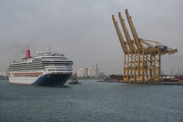 Modern cruiseship or cruise ship liner Freedom arrival into port of Barcelona Espana, Spain gateway...