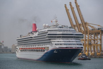 Modern cruiseship or cruise ship liner Freedom arrival into port of Barcelona Espana, Spain gateway...