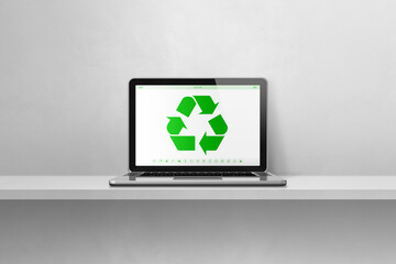 Fototapeta premium Laptop computer on a shelf with a recycling symbol on screen. environmental conservation concept