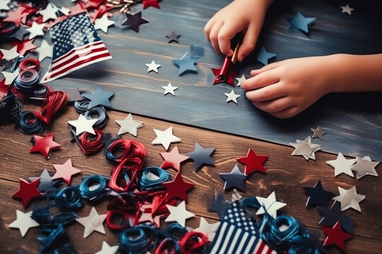 A close-up of a child's hands creating a patriotic-themed photo collage or scrapbook, showcasing creativity and family involvement, creativity with copy space