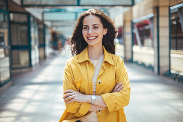Portrait of a Stylish Pretty Young Woman in Autumn Fashion walking the city Looking at the Camera. Close-up portrait of beautiful caucasian woman with charming smile walking outdoors