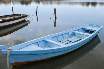 Old wooden traditional fishing boat in shallow water, authentic fishing boat from Nin, Croatia