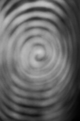 A blurry dreamy view of a spiral in black and white.