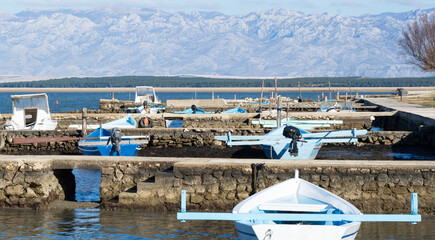 Port with traditional wooden fishing boats in shallow waters, authentic from Nin, Croatia