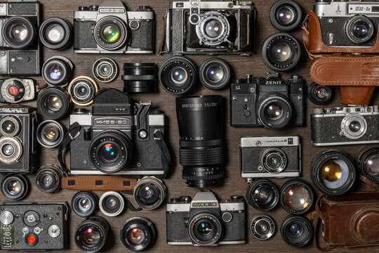 Various vintage photo cameras , 35mm film, and old lenses made in USSR, close up, top view