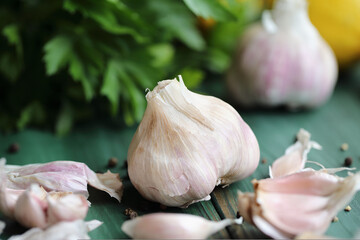 Fresh garlic cloves and ingredients to make toum sauce or a salad dressing. Closeup stock photo with selective focus and blurred background.