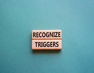 Recognize triggers symbol. Concept words Recognize triggers on wooden blocks. Beautiful grey green...