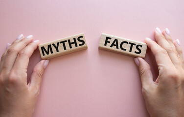 Facts or Myths symbol. Concept word Facts or Myths on wooden blocks. Businessman hand. Beautiful...