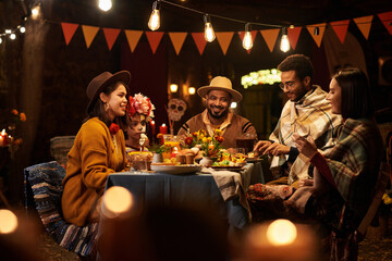 People having dinner party together in honour of holiday of dead