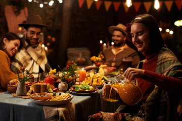 Big family sitting at dining table and celebrating traditional holiday together