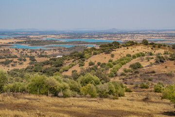 Fototapeta na wymiar Mount with dried herbs, typical Alentejo landscape with Alqueva dam in the background and mountains of Spain on the horizon, Monsaraz PORTUGAL