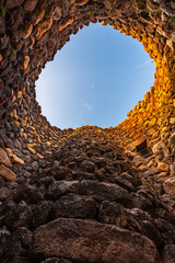 Inside of the bronze age fort UNESCO world heritage site Su Nuraxi di Barumini on Sardinia island during sunset. 