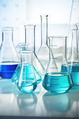 Laboratory equipment beakers and flask with backlight in different group. AI Generated