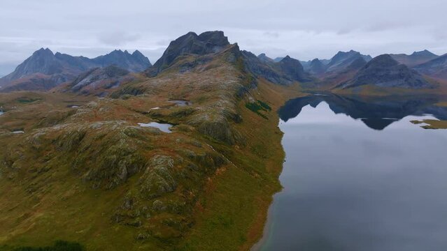 Aerial View from a Hill, Unfolding the Stunning Ocean and Towering Mountain Peaks in Norway