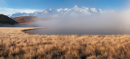 Beautiful sunny foggy morning in the mountains. Autumn frost on dry grass. Snowy peaks. North Chuysky Range and Lake Dzhangyskol. Russia, Altai Republic. Panoramic view. - obrazy, fototapety, plakaty