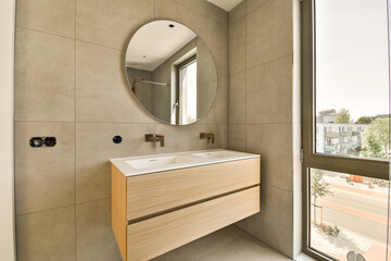 a bathroom with a large mirror above the sink and vanity in front of glass door that leads to an...