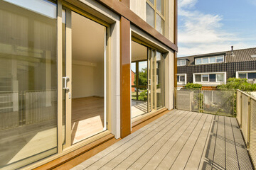 an outside area with wooden decking and sliding glass doors that open onto the balcony to let in natural light