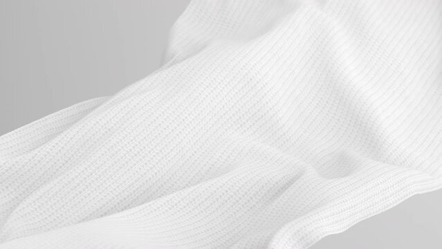 White fabric waving slowly, soft woolen cloth isolated on white background.