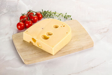 Maasdam cheese brick over board
