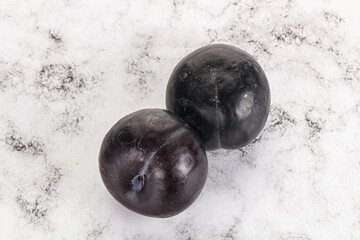 Two ripe sweet black plums