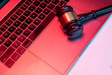 Gavel on keyboard closeup view - cyber justice concept