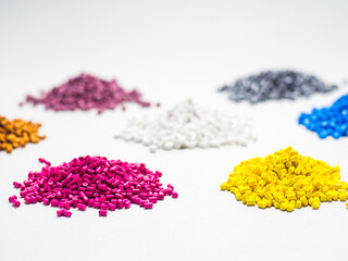 various colored masterbatch granules isolated on a white background, this polymer is a colorant for products in the plastics industry