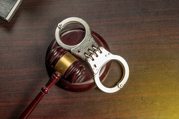 Handcuff with judge gavel table top view