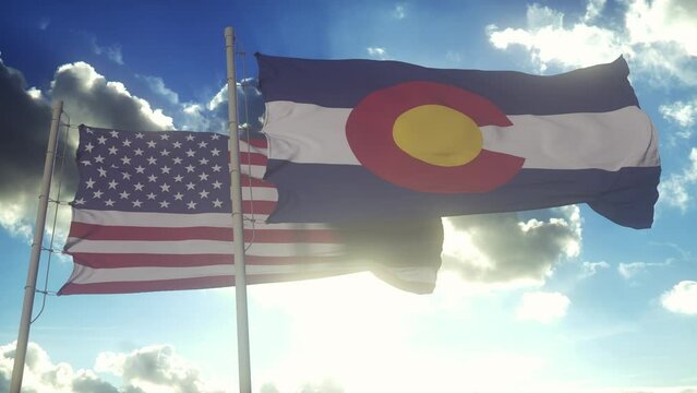 The flags of the Colorado state and United States of America waving in the wind. American state. Concept of democracy and independence
