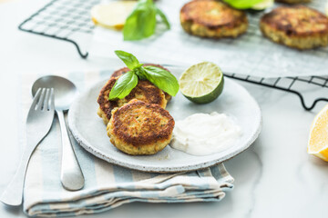 Traditional homemade fish cakes with tlemon and sour cream