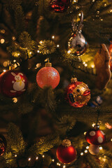 Christmas glass toys on the Christmas tree among New Year's tinsel. Pink Puffer Fish Christmas Toy....