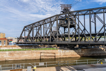 Historic swing span of the Arsenal or Government bridge swings open over the Lock and Dam No. 15 in...
