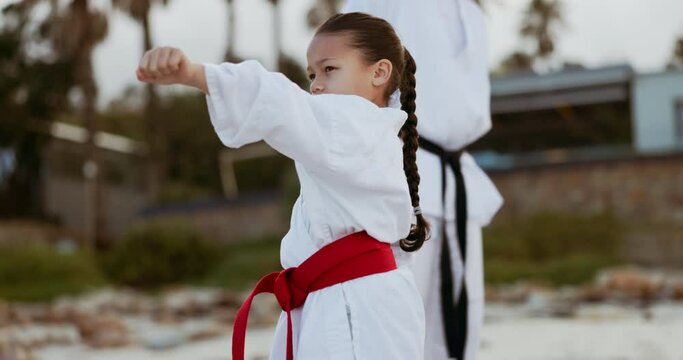 Karate, training and girl child with trainer man outdoor for self defense, learning or fighting. Martial arts, fitness and kid with instructor in nature for Taekwondo practice or protection lesson