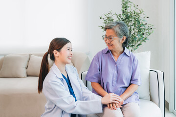 Fototapeta premium Medical staff taking and caregiver senior woman in Home. Healthcare and Home Care Concept. Female professional doctor.