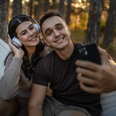 Man and woman young adult couple in nature self portrait selfie
